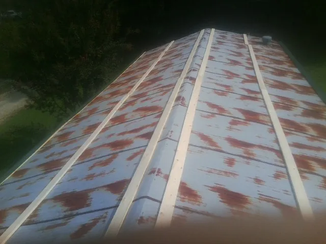 Rusted metal roof panels with new wood purlins before replacement — Storm Damage Roof Repair in San Gabriel by Roofing Brothers