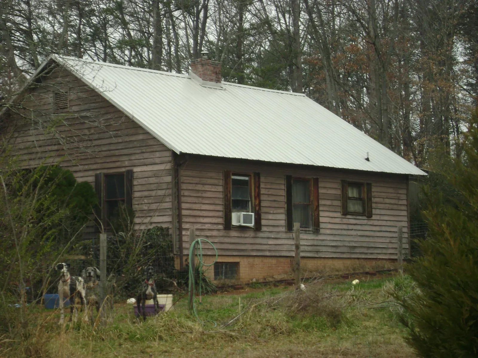 White metal roof on an old wood sided farmhouse, from a Metal Roof Installation job in San Gabriel
